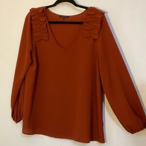 Staccato Rust Blouse with Ruffle Accents